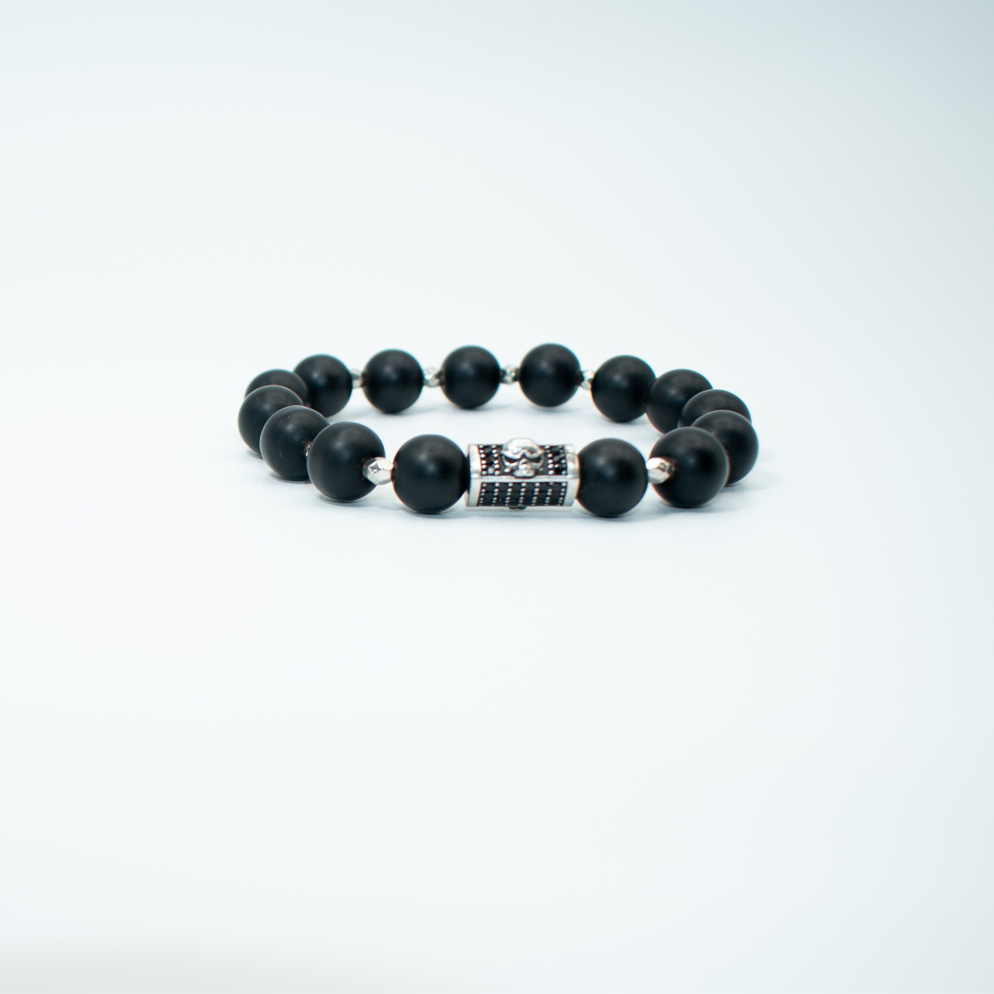 PRODUCT DETAILS 10mm Matte Black Onyx Beads Silver/Black Skull Charm Stretch 7.5 Inches 1.2 oz Handmade in USA We use premium durable materials and stones in our jewelry. All pieces may vary slightly in color, shape, and size. Please measure your wrist before you make your purchase for an accurate fit. Please leave a message if you need a different size. You will receive a free: Storage box or bag and cleaning cloth with your order.