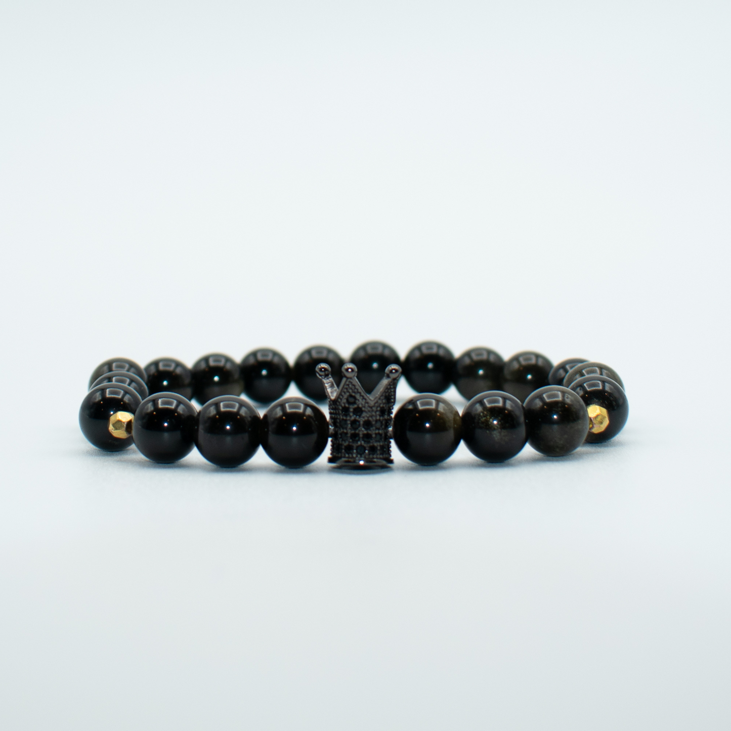 PRODUCT DETAILS 8mm Golden Obsidian Beads Black Crown Charm Stretch 7.5 Inches 0.9oz Handmade in USA We use premium durable materials and stones in our jewelry. All pieces may vary slightly in color, shape, and size. Please measure your wrist before you make your purchase for an accurate fit. Please leave a message if you need a different size. You will receive a free: Storage box or bag and cleaning cloth with your order.