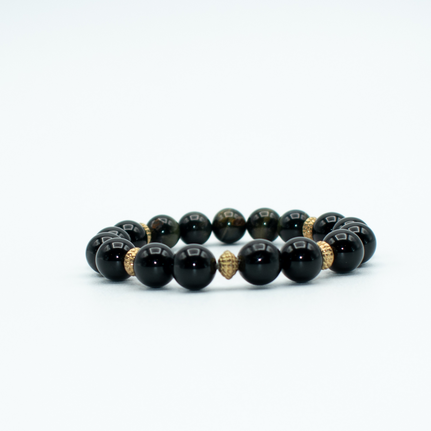 PRODUCT DETAILS 8mm Golden Obsidian Beads 8mm Onyx Beads 1.2 oz Handmade in USA We use premium durable materials and stones in our jewelry. All pieces may vary slightly in color, shape, and size. Please measure your wrist before you make your purchase for an accurate fit. This is a final sale item. No refunds, no exchanges, no returns. You will receive a free: Storage box or bag and cleaning cloth with your order.